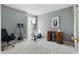 Bedroom features neutral paint, carpet, a desk and some workout equipment next to the window at 10875 Santa Anita Ct, Carmel, IN 46280
