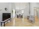 Open dining room with hardwood floors, vaulted ceilings, and a view into the kitchen at 10875 Santa Anita Ct, Carmel, IN 46280