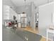 Open kitchen with stainless steel appliances, grey countertops, and hardwood floors at 10875 Santa Anita Ct, Carmel, IN 46280