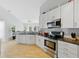 Bright kitchen with stainless steel appliances, sleek countertops, and hardwood floors at 10875 Santa Anita Ct, Carmel, IN 46280