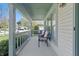 Cozy front porch with seating, perfect for relaxing and enjoying the neighborhood views at 10875 Santa Anita Ct, Carmel, IN 46280