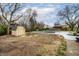 Backyard featuring a shed, an in-ground pool, and a concrete patio with mulch landscaping at 1107 Leisure Ln, Greenwood, IN 46142