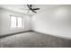 Minimalist bedroom with plush carpet, a ceiling fan, and a bright window at 1107 Leisure Ln, Greenwood, IN 46142