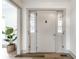 Bright entryway featuring a white front door, hardwood floors, and plant at 1107 Leisure Ln, Greenwood, IN 46142