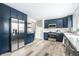 Spacious kitchen featuring blue cabinets, stainless steel appliances, and hardwood floors at 1107 Leisure Ln, Greenwood, IN 46142