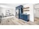 Open-concept kitchen with blue cabinets, stainless steel refrigerator, and adjacent living area at 1107 Leisure Ln, Greenwood, IN 46142