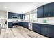 Beautiful kitchen with blue cabinets, stainless steel appliances, and wood floor at 1107 Leisure Ln, Greenwood, IN 46142