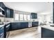 Modern kitchen with blue cabinets, stainless steel appliances, and white subway tile backsplash at 1107 Leisure Ln, Greenwood, IN 46142