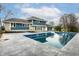 A refreshing in-ground pool sits next to a blue two story house at 1107 Leisure Ln, Greenwood, IN 46142