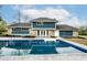 A refreshing in-ground pool sits next to a blue two story house at 1107 Leisure Ln, Greenwood, IN 46142