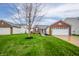 Charming home featuring a brick facade, well-manicured lawn, and attached two-car garage at 12319 Wolf Run Rd, Noblesville, IN 46060