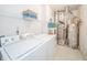 Laundry room with white washer and dryer, water heater, and shelves for storage at 12319 Wolf Run Rd, Noblesville, IN 46060