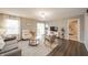 Bright living room with comfortable seating, modern decor, and a sliding door to the patio at 12319 Wolf Run Rd, Noblesville, IN 46060