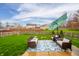 Outdoor patio setup with stylish furniture, a verdant lawn, and a privacy fence at 12319 Wolf Run Rd, Noblesville, IN 46060