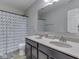 Bathroom with double vanity, modern faucets, and a shower with decorative curtain at 1232 Blue Haven Way, Greenwood, IN 46143