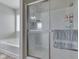 Clean bathroom with a glass-enclosed shower and separate bathtub at 1232 Blue Haven Way, Greenwood, IN 46143