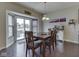 Dining room with a wooden table set, sliding glass doors to the patio, and stylish decor at 1232 Blue Haven Way, Greenwood, IN 46143