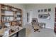 Comfortable home office with wood shelving and a cozy seating area at 1232 Blue Haven Way, Greenwood, IN 46143