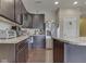 Spacious kitchen featuring dark cabinets, stainless steel appliances, and wood flooring at 1232 Blue Haven Way, Greenwood, IN 46143