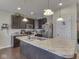 Kitchen with stainless steel appliances, island counter with sink, and dark wood cabinets at 1232 Blue Haven Way, Greenwood, IN 46143