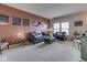 Comfortable living room with stylish gray furniture, neutral carpet, and warm accent wall at 1232 Blue Haven Way, Greenwood, IN 46143