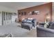 Inviting living room with plush gray seating, neutral carpet, warm accent wall, and tasteful decor at 1232 Blue Haven Way, Greenwood, IN 46143