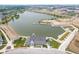 Aerial view of a lake with clubhouse, beach, and new construction at 13107 Pennington Rd, Fishers, IN 46037