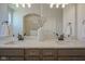 Modern bathroom with double sinks, quartz countertops, dark wood cabinets, large mirror and modern fixtures at 13107 Pennington Rd, Fishers, IN 46037