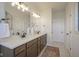 Bathroom featuring double sinks, quartz countertops, dark wood cabinets, and a decorative rug at 13107 Pennington Rd, Fishers, IN 46037