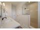 Beautiful bathroom featuring a tiled shower with glass enclosure and double sink vanity with quartz countertops at 13107 Pennington Rd, Fishers, IN 46037