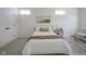 Cozy bedroom with neutral decor, including a comfortable bed with pillows and throw, and two modern windows at 13107 Pennington Rd, Fishers, IN 46037