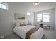 Bright bedroom with modern decor, including a comfortable bed, two windows, and two accent chairs at 13107 Pennington Rd, Fishers, IN 46037