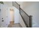 Bright foyer with a staircase featuring dark wood banisters and carpeted treads, complemented by light walls at 13107 Pennington Rd, Fishers, IN 46037