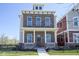 Charming brick two-story home featuring a welcoming front porch and professionally landscaped front yard at 13107 Pennington Rd, Fishers, IN 46037