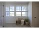 A bright hallway featuring a bench, large windows and ample natural light at 13107 Pennington Rd, Fishers, IN 46037