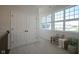 A naturally lit hallway with double door closet, a bench and a large window at 13107 Pennington Rd, Fishers, IN 46037
