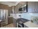 Well-appointed kitchen features stainless steel appliances and sleek countertops at 13107 Pennington Rd, Fishers, IN 46037