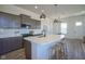 Spacious kitchen featuring an island with seating, stainless steel appliances, and stylish lighting at 13107 Pennington Rd, Fishers, IN 46037