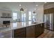 Modern kitchen showcasing a large island, stainless steel appliances, and designer lighting at 13107 Pennington Rd, Fishers, IN 46037