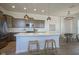 Modern kitchen showcasing a large island, stainless steel appliances, and designer lighting at 13107 Pennington Rd, Fishers, IN 46037