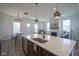 Open-concept living area with kitchen island, fireplace, and dining space at 13107 Pennington Rd, Fishers, IN 46037