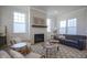 Comfortable living room showcasing a decorative fireplace, large windows, and stylish furniture at 13107 Pennington Rd, Fishers, IN 46037