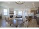 Open-concept living area with fireplace, modern kitchen, dining area and lots of natural light at 13107 Pennington Rd, Fishers, IN 46037