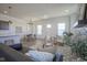 Open-concept living area with fireplace, modern kitchen, dining area and lots of natural light at 13107 Pennington Rd, Fishers, IN 46037