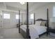 Spacious main bedroom with four poster bed, tray ceiling and large windows at 13107 Pennington Rd, Fishers, IN 46037