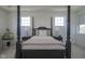 Bright main bedroom featuring a stylish four-poster bed, neutral decor, and natural lighting at 13107 Pennington Rd, Fishers, IN 46037