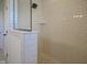 Bright white shower with tile walls and floor, featuring a shower head with glass enclosure at 13107 Pennington Rd, Fishers, IN 46037