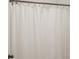 Close up of shower curtain and bronze curtain rod in bathroom at 13107 Pennington Rd, Fishers, IN 46037