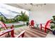 Comfortable outdoor living on the covered back porch with a striped rug, adirondack chairs and pleasant views at 1401 Farmhouse Dr, Westfield, IN 46074