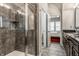 Modern bathroom featuring a large shower with gray tiling and vanity with dark cabinets and granite countertop at 1401 Farmhouse Dr, Westfield, IN 46074